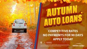 A white car surrounded by fall foliage