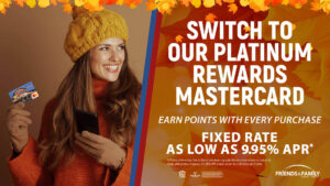 A woman dressed in fall fashion with a credit card