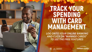 Man looking at his credit card and a laptop