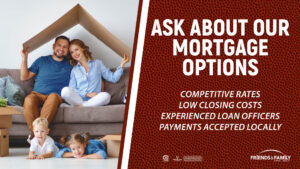A mom and dad holding cardboard like a roof as two kids play on the floor