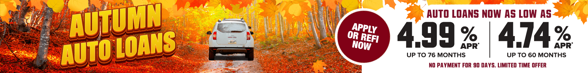 A white car surrounded by fall foliage