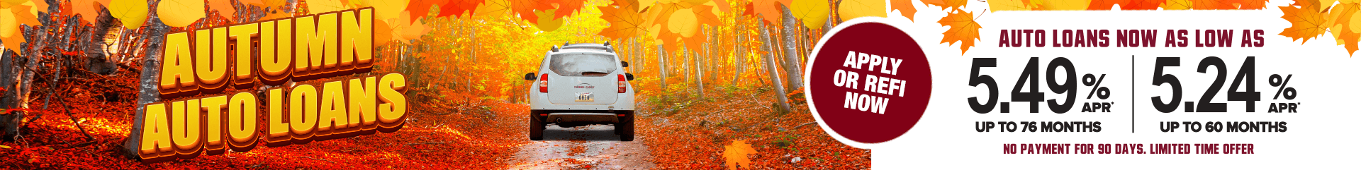 A white car surrounded by fall leaves